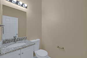 Half bath featuring vanity and toilet
