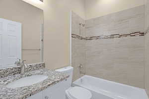 Full bath with toilet, vanity, and shower / washtub combination
