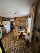 Dining area featuring wooden walls