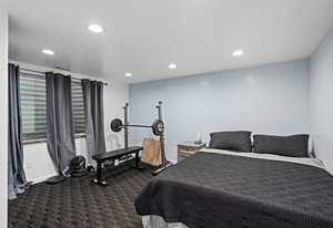 Bedroom with dark colored carpet and recessed lighting