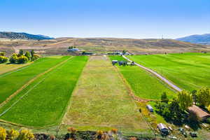 Aerial view featuring a rural view and a mountain view
