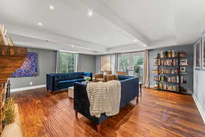 Living room featuring baseboards, wood finished floors, french doors, and a healthy amount of sunlight