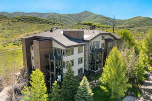 Aerial view of property and surrounding area with mountains