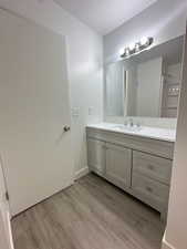 Bathroom featuring vanity and wood finished floors