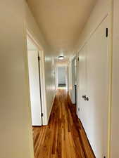 Hallway with baseboards and dark wood finished floors