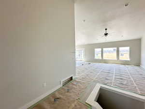 Unfurnished living room with baseboards and a ceiling fan