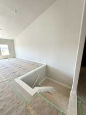 Bonus room with baseboards and a textured ceiling
