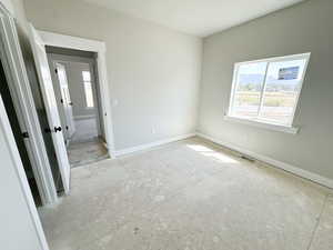Unfurnished bedroom with baseboards