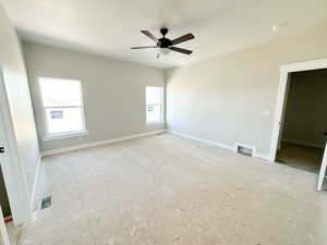 Spare room with ceiling fan and baseboards