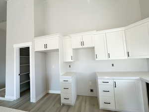 Kitchen featuring white cabinetry and light wood-style floors