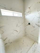 Bathroom with a marble finish shower