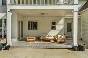 View of patio featuring outdoor lounge area, a balcony, and ceiling fan