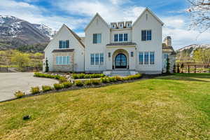 View of front of house featuring a standing seam roof, fence, metal roof, and a mountain view