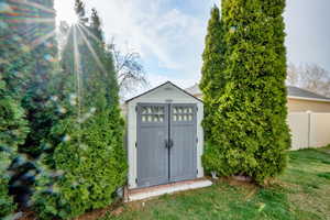 View of shed with fence
