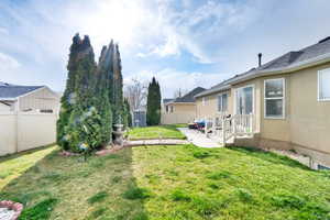 View of yard with a patio area, a fenced backyard, an outdoor structure, and a shed