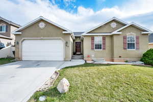 Single story home with an attached garage, fence, stucco siding, a front lawn, and driveway