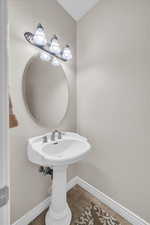 Bathroom with tile patterned floors and baseboards