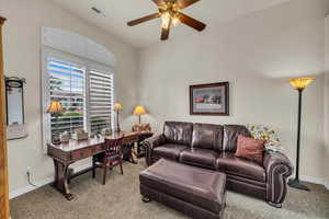 Living room with baseboards, a ceiling fan, visible vents, and carpet floors
