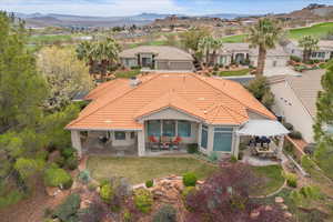 Rear view of house with a patio area, a residential view, and a tile roof