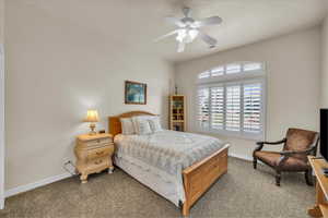 Bedroom with carpet, visible vents, baseboards, and ceiling fan