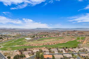 Aerial view with golf course view, a mountain view, and a residential view