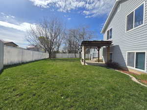 View of yard featuring a patio area, a fenced backyard, and a pergola