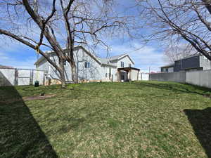 View of yard featuring a fenced backyard and a gate