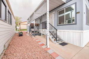 View of side of home featuring a patio area
