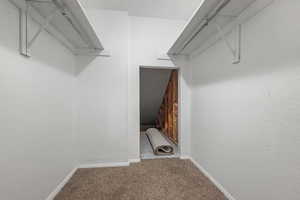 Walk in closet featuring carpet flooring