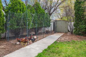 View of home's community with fence, exterior structure, and an outbuilding