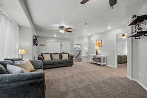 Living room featuring recessed lighting, carpet, baseboards, and a ceiling fan