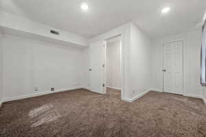 Interior space featuring visible vents, baseboards, carpet, and recessed lighting