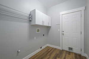 Laundry room featuring hookup for an electric dryer, washer hookup, baseboards, dark wood-style floors, and cabinet space