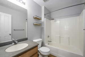 Full bathroom featuring visible vents, toilet, shower / bathing tub combination, and vanity