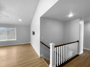 Interior space with baseboards, recessed lighting, and wood finished floors