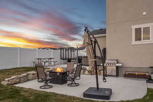 View of patio / terrace featuring an outdoor fire pit, fence, and grilling area