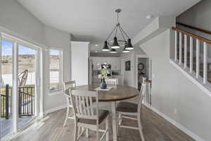 Dining space featuring baseboards, a chandelier, recessed lighting, stairway, and light wood-style floors