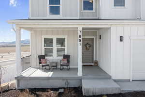 Property entrance with a porch, board and batten siding, and a mountain view