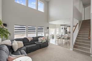 Living area featuring stairway and light wood-style floors