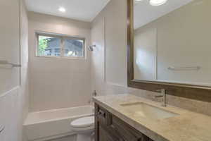 Full bath with toilet, vanity, and shower / bathtub combination