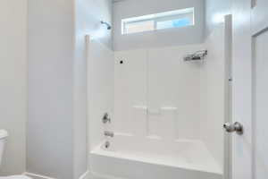 Full bath featuring toilet and shower / bathtub combination