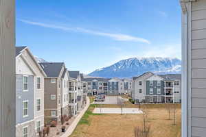 Exterior space with a mountain view, a residential view, and a lawn
