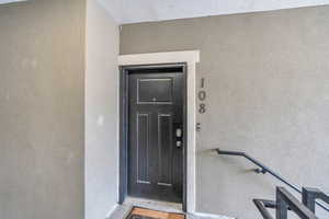 View of exterior entry featuring stucco siding