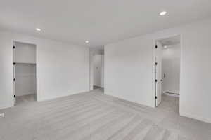 Unfurnished bedroom with carpet flooring, baseboards, and recessed lighting
