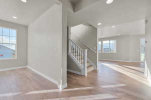 Interior space with light wood-type flooring, recessed lighting, baseboards, and stairs