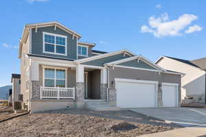 Craftsman inspired home featuring stucco siding, a porch, stone siding, an attached garage, and concrete driveway