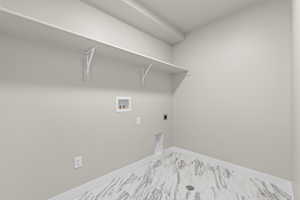 Washroom featuring laundry area, marble finish floor, washer hookup, hookup for an electric dryer, and baseboards
