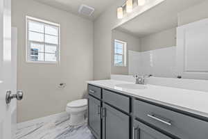 Bathroom featuring vanity, baseboards, toilet, visible vents, and marble finish floor