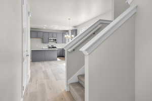 Stairs featuring recessed lighting, a notable chandelier, and hardwood / wood-style flooring