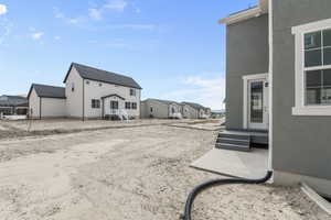View of yard with entry steps and a residential view
